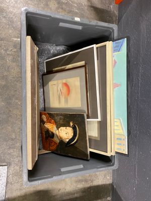 an open box with pictures and a cup inside of it