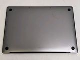 the back of a silver laptop computer sitting on top of a white table