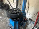 a tire changer that is sitting in a garage