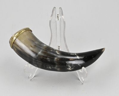 a horn shaped object on a clear stand on a white surface