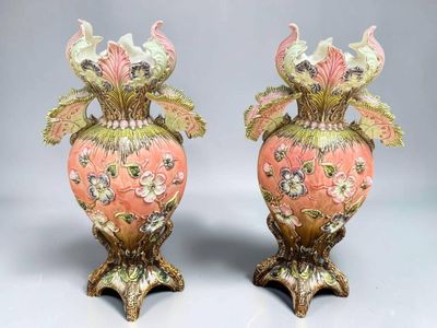 two vases that have been decorated with flowers on them