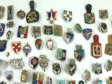 many different types of badges on a white surface