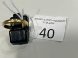 une bague noire et dorée, surmontée d'un anneau doré