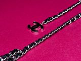 a close up of a chain on a pink surface