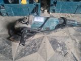 an image of a drill on the ground next to other tools