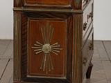 a small wooden cabinet with a marble top on a wooden floor