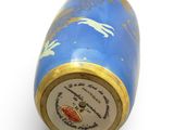 a blue and gold vase with a bird on it