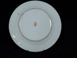 a white plate with a red design on it
