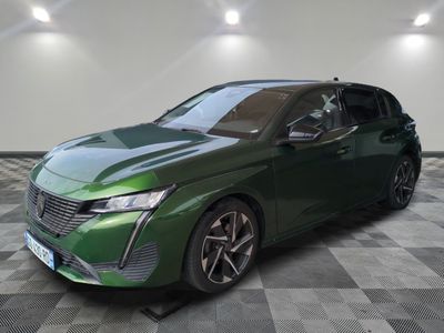 the green car is parked on a checkered floor in a room