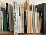 many books that are on a wooden shelf