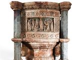 a statue of a group of people sitting on top of a pedestal
