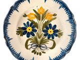 a blue and white plate with yellow flowers on it