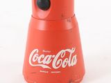 an old coca cola canister with a black lid