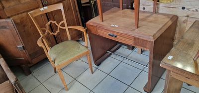 a wooden desk and chair in a room with a tile floor