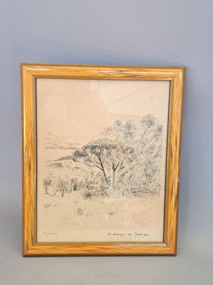 painting of a landscape in a wooden frame on a blue wall