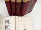 six red books with illustrations on them sitting on a white surface