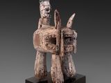 an image of a wooden sculpture of a horse and rider