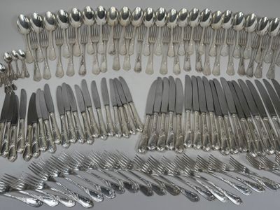 many forks and spoons laid out on the table