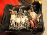 a basket full of wrenches and other tools in it