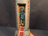 a model of a space rocket with a man on it