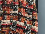 a close up of a multicolored skirt with a black top