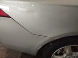 a close up of a car ' s rear end with the door open