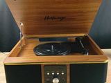 a record player that is sitting on a wooden table