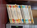 a lot of books that are on a shelf