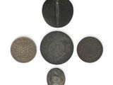 several coins are arranged in a circle on a white surface