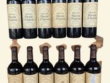 six bottles of wine are lined up in a row on a table