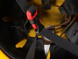 a close up of a helmet with a red handle on it