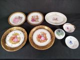 several plates and bowls are sitting on a black table