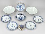 several blue and white plates and bowls are arranged in a circle