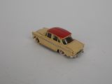 yellow toy car with a red roof on a white surface
