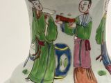 a white vase with a painting of a man and a woman on it