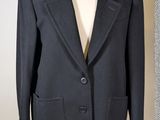 two jackets on a mannequin stand in a clothing store