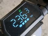 a digital clock on the handlebar of a bike