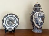 two blue and white vases sitting on a wooden table