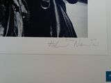 signed photograph of a man in a leather jacket holding a cigarette