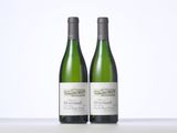 two bottles of wine sitting on top of a table next to each other