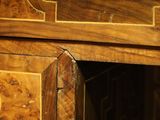 a close up of a wooden desk with a clock on it