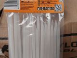 a bunch of white plastic straws sitting on a box
