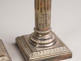 pair of silver plated candlesticks with a carved design