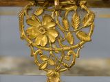 a glass box with a gold decoration on top of it