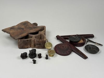 a small wooden box with various items on it