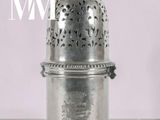 a silver cup that is sitting on a table