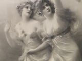an old photo of two women in white dresses standing next to each other