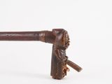 a wooden stick with a handle that has a face on it