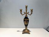 a black and gold vase sitting on a white table
