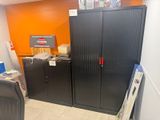 a black cabinet in the corner of a room with orange walls